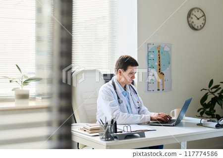 Medical Professional Using Laptop in Pediatric Office 117774586