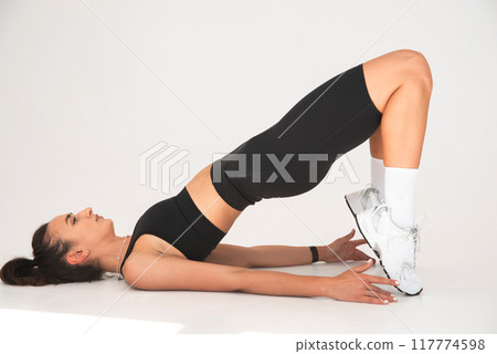 Smiling healthy woman doing yoga at home. white background Smiling healthy woman doing yoga at home. white background 117774598