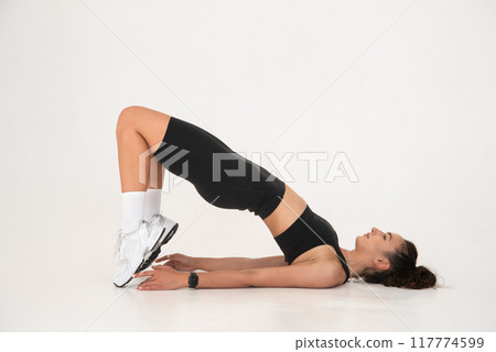 Smiling healthy woman doing yoga at home. white background Smiling healthy woman doing yoga at home. white background 117774599