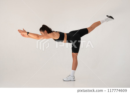 Smiling healthy woman doing yoga at home. white background 117774609