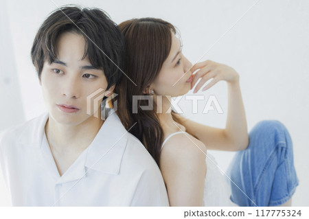 A couple wearing matching denim outfits 117775324