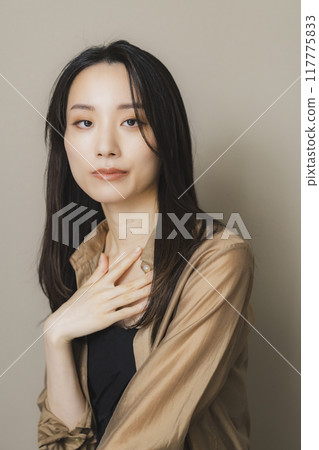 Woman in brown blouse Woman in brown blouse 117775833