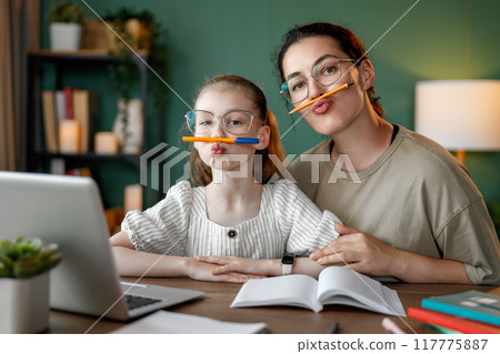 Girl doing homework or online education. Girl doing homework or online education. 117775887
