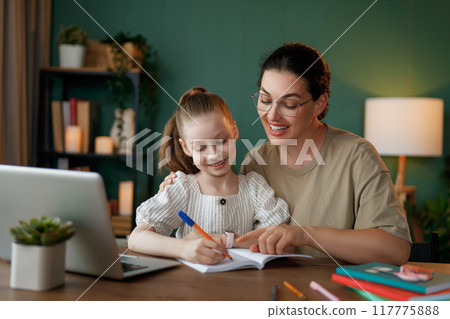 Girl doing homework or online education. 117775888