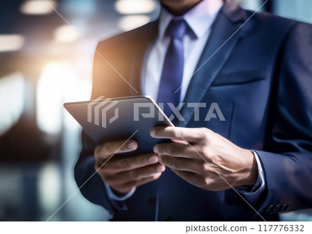 Image of a businessman looking at a tablet 117776332