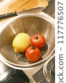 Cherry tomatoes and lemons lined up in the kitchen 117776507