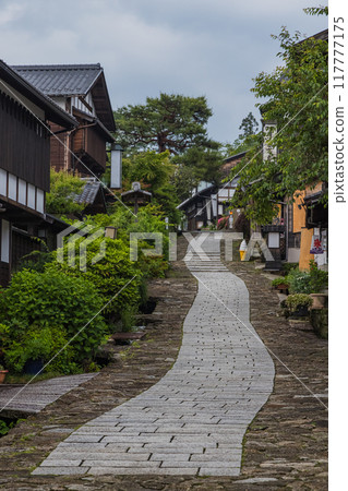 Japan: Stone-paved slopes and houses of Magome-juku, a post town on the Nakasendo road in Nakatsugawa City, Gifu Prefecture 117777175