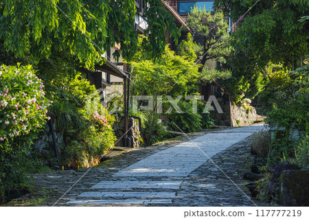 Japan: Stone-paved slopes and houses of Magome-juku, a post town on the Nakasendo road in Nakatsugawa City, Gifu Prefecture 117777219