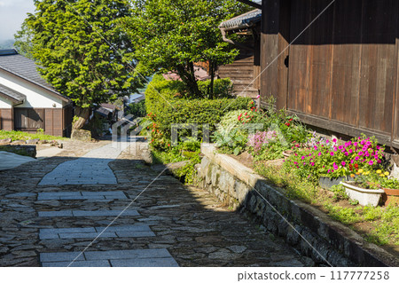 Japan: The stone-paved slopes and streetscape of Magome-juku, a post town on the Nakasendo road in Nakatsugawa City, Gifu Prefecture 117777258