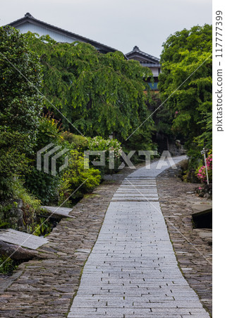 Japan: The stone-paved slopes and streetscape of Magome-juku, a post town on the Nakasendo road in Nakatsugawa City, Gifu Prefecture 117777399