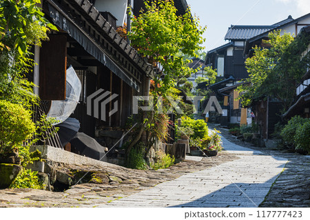 Japan: The stone-paved slopes and streetscape of Magome-juku, a post town on the Nakasendo road in Nakatsugawa City, Gifu Prefecture 117777423