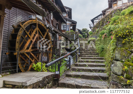 Japan: The hills, streetscape and waterwheel of Magome-juku, a post town on the Nakasendo road in Nakatsugawa City, Gifu Prefecture Japan: The hills, streetscape and waterwheel of Magome-juku, a post town on the Nakasendo road in Nakatsugawa City, Gifu Prefecture 117777532