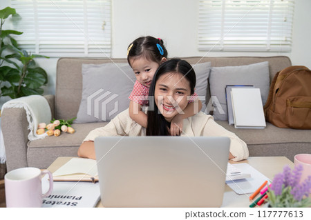 Mother and Child Sharing a Warm Moment with Laptop Mother and Child Sharing a Warm Moment with Laptop 117777613
