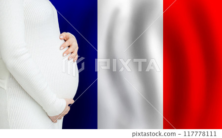 Pregnant woman belly against French flag background. Demographics and pregnancy in France concept Pregnant woman belly against French flag background. Demographics and pregnancy in France concept 117778111