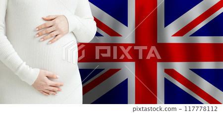 Pregnant woman belly against Flag of the United Kingdom background.  117778112