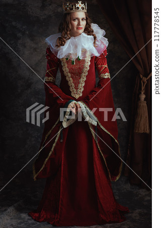 Full length portrait of smiling medieval queen in red dress Full length portrait of smiling medieval queen in red dress 117778545