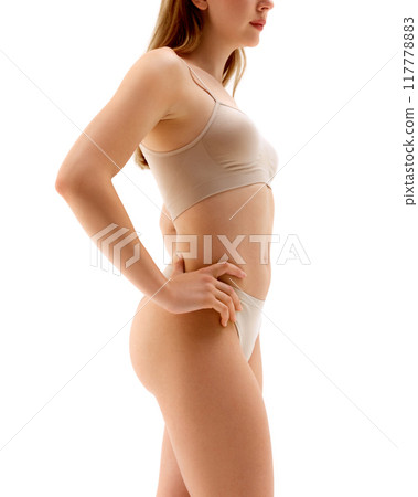 Healthy lifestyle, sport and nutrition. Cropped image of female fit slim body , model posing in underwear, isolated on white background 117778883