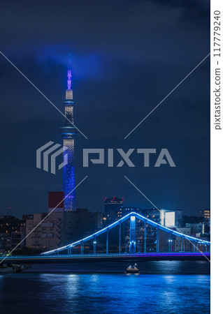 Night view from the Sumida River Bridge in Chuo Ward, Tokyo, Japan, with the illuminated Tokyo Skytree and Kiyosu Bridge 117779240
