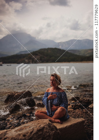 Woman's hands on her chest while doing breathing exercises Woman's hands on her chest while doing breathing exercises 117779629