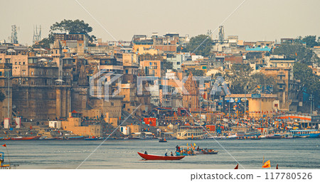Varanasi, Uttar Pradesh, India. Boats Floating Near Rana Mahal Ghat, Darbhanga Ghat And Dashashwamedh Ghat In Early Morning. Many Hindu Temples. View From Riverbank Embankment 117780526