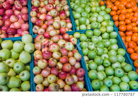 New harvest of fruits on the market, green and red apples and tangerine. New harvest of fruits on the market, green and red apples and tangerine. 117780787