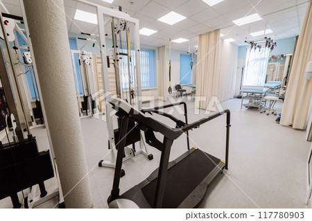 Rehabilitation room equipped with advanced therapy tools and equipment for patient recovery Rehabilitation room equipped with advanced therapy tools and equipment for patient recovery 117780903