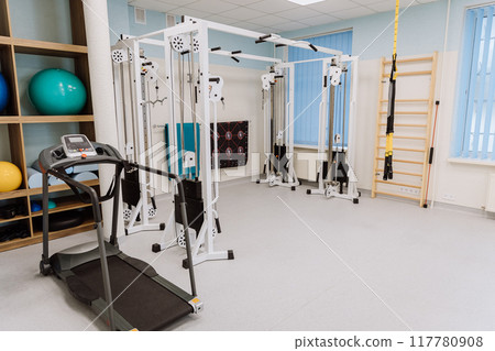 Fitness gym with professional equipment for workouts and physical therapy - perfect for training Fitness gym with professional equipment for workouts and physical therapy - perfect for training 117780908