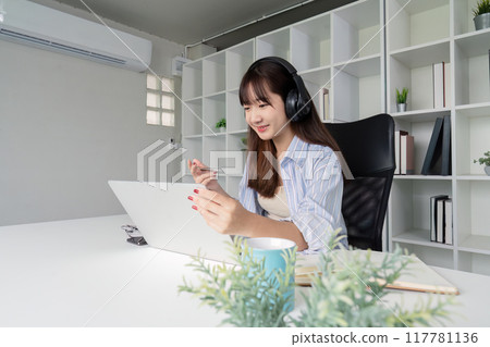 Focused Woman Engaging in Online Study Session at Home Focused Woman Engaging in Online Study Session at Home 117781136
