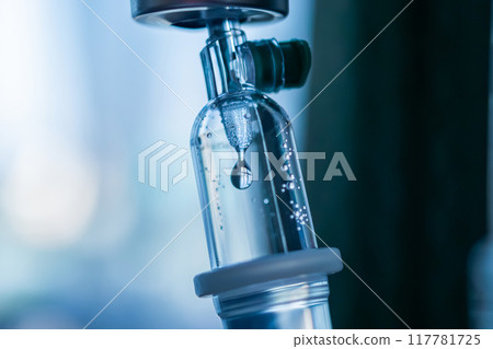 Close up medical intravenous IV drip in hospital background 117781725