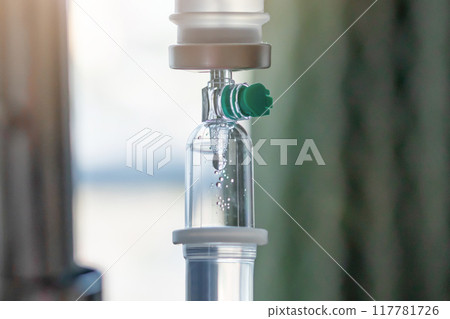 Close up medical intravenous IV drip in hospital background 117781726