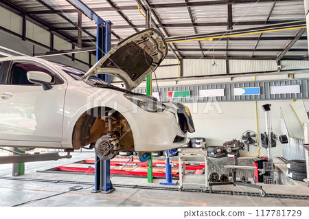 White car in car service centre auto repair workshop White car in car service centre auto repair workshop 117781729