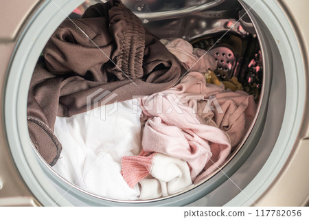 Washing machine loaded with clothes close up 117782056