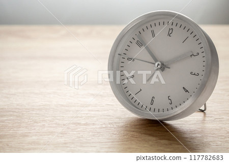 Silver alarm clock on wood table background 117782683