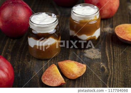 fresh yogurt with jam and pieces of ripe nectarine fresh yogurt with jam and pieces of ripe nectarine 117784098