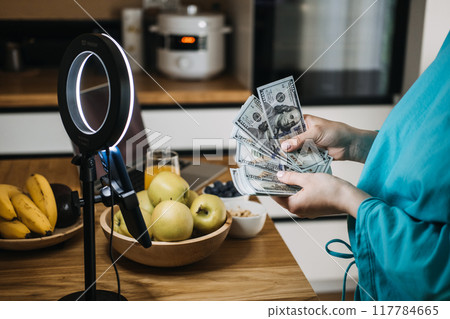 Content creator counting money during live stream, influencer marketing, financial success, digital entrepreneurship, online earnings, social media revenue 117784665