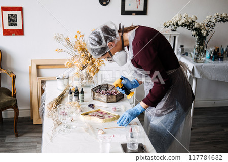 Creating beautiful epoxy resin art: A DIY project in a bright studio space in the afternoon Creating beautiful epoxy resin art: A DIY project in a bright studio space in the afternoon 117784682