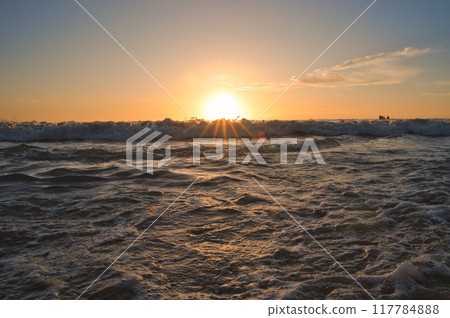 Sunset and waves on a beach in Hawaii Sunset and waves on a beach in Hawaii 117784888