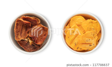 Bowl plates with dried healthy organic persimmon kaki pieces isolated on white background. 117786637