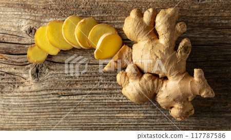 Ginger on a old wooden board. 117787586
