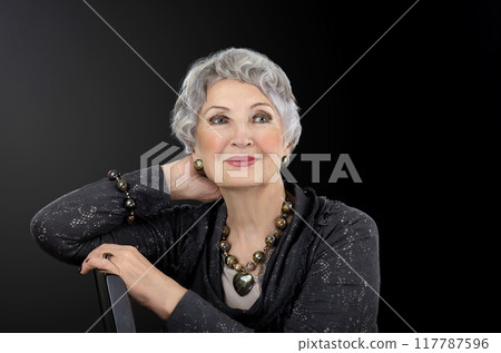 Defying Age with Poise: 76-Year-Old Beauty Icon Dazzles in Gemstone Accessories and Classic Attire. 117787596