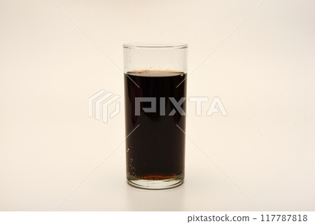 A glass glass with soda on a white background. Juice in a glass. A glass glass with soda on a white background. Juice in a glass. 117787818
