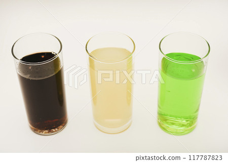 Glass glasses with soda on a white background. Juice in three glasses. Glass glasses with soda on a white background. Juice in three glasses. 117787823