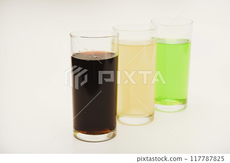 Glass glasses with soda on a white background. Juice in three glasses. Glass glasses with soda on a white background. Juice in three glasses. 117787825