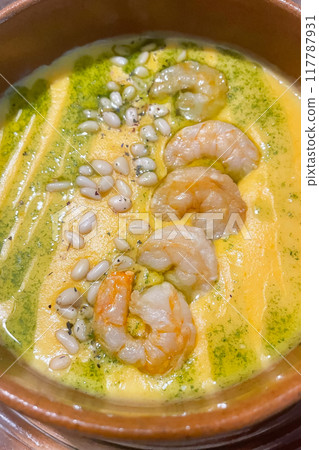 cheese soup with shrimp and pine nuts close-up cheese soup with shrimp and pine nuts close-up 117787931