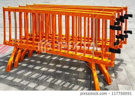 Movable foldable temporary orange plastic barrier sections for regulating people flow at events Movable foldable temporary orange plastic barrier sections for regulating people flow at events 117788091