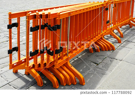 Movable foldable temporary orange plastic barrier sections for regulating people flow at events Movable foldable temporary orange plastic barrier sections for regulating people flow at events 117788092