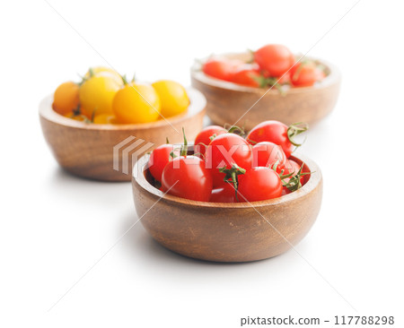 Different colorful cherry tomatoes in bowl isolated on white background. Different colorful cherry tomatoes in bowl isolated on white background. 117788298