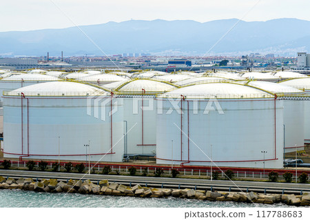 Many large round white reservoirs of chemical products in the port industrial terminal 117788683