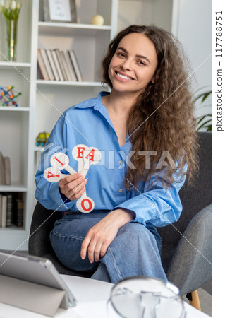 Smiling young speech therapist feeling happy after a good session Smiling young speech therapist feeling happy after a good session 117788751