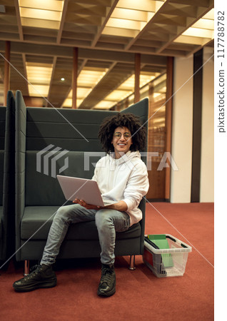 Young male student using laptop for remote studying preparing for seminars in library Young male student using laptop for remote studying preparing for seminars in library 117788782